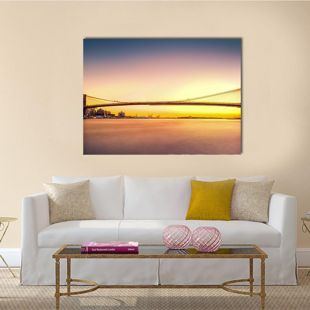 Brooklyn Bridge at Sunset Canvas Wall Art in orange, yellow and blue, single panel hung on a wall