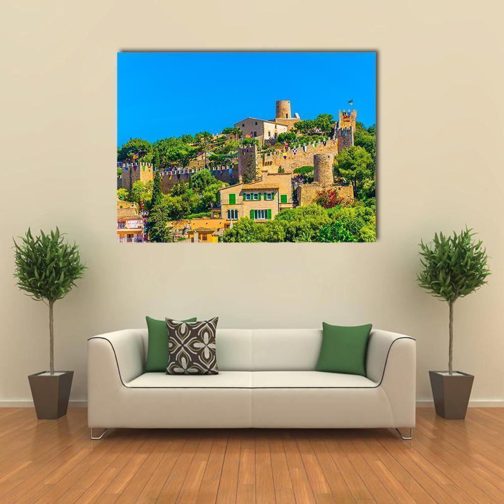 Capdepera Castle Above Hillside Town Canvas Wall Art in beige, green and blue, single panel hung on a wall