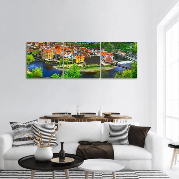 Cesky Krumlov Aerial River View Panoramic Canvas Wall Art in orange, green and blue, hung on a wall
