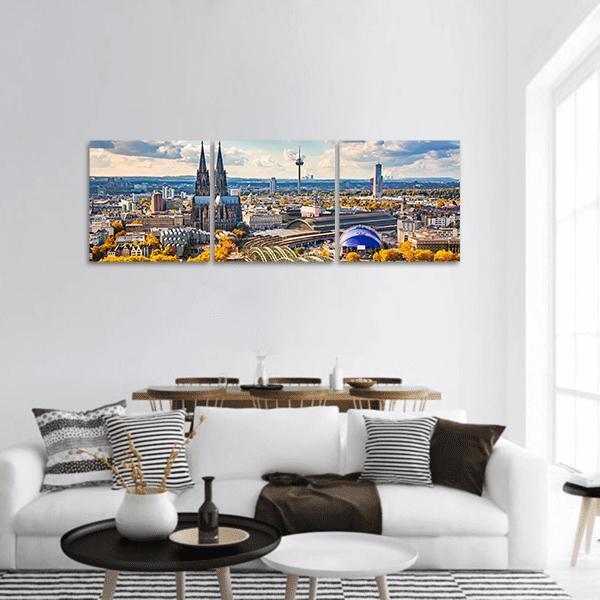 Cologne Skyline with Kölner Dom Panoramic Canvas Wall Art in gray, yellow and blue, hung on a wall