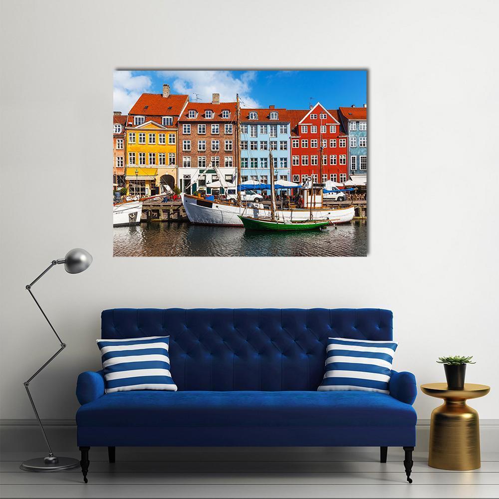Colorful Buildings and Boats at Nyhavn Canvas Wall Art in red, blue and multicolor, single panel hung on a wall