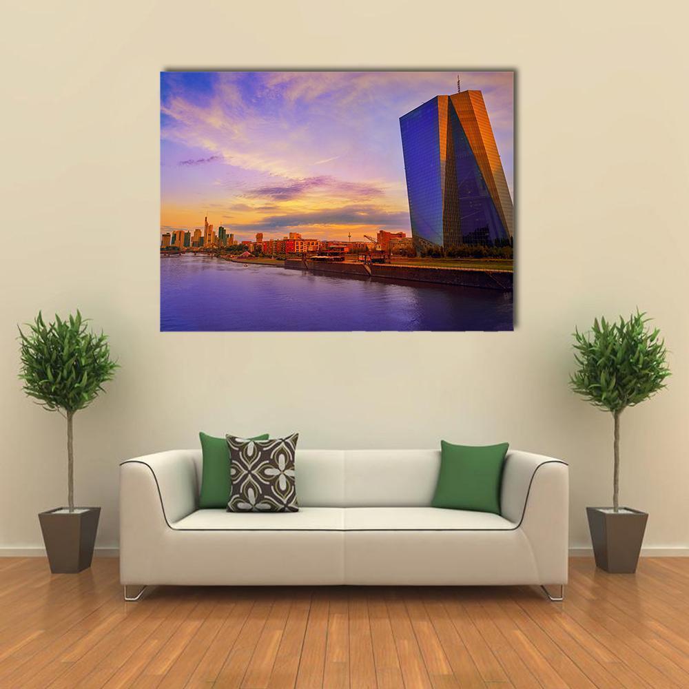 Frankfurt Skyline with Meno River Canvas Wall Art in orange, blue and purple, single panel hung on a wall