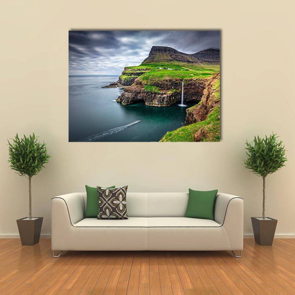 Gasadalur Waterfall on Coastal Cliffs Canvas Wall Art in gray, green and blue, single panel hung on a wall