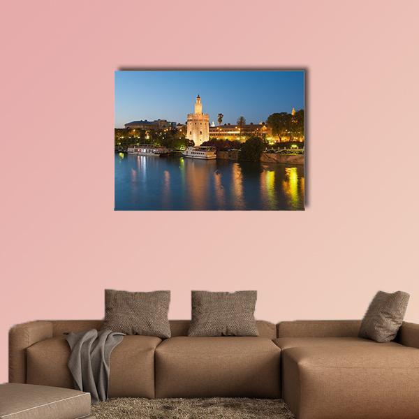 Torre Del Oro Seville Night River View Canvas Wall Art in gold, yellow and blue, single panel hung on a wall