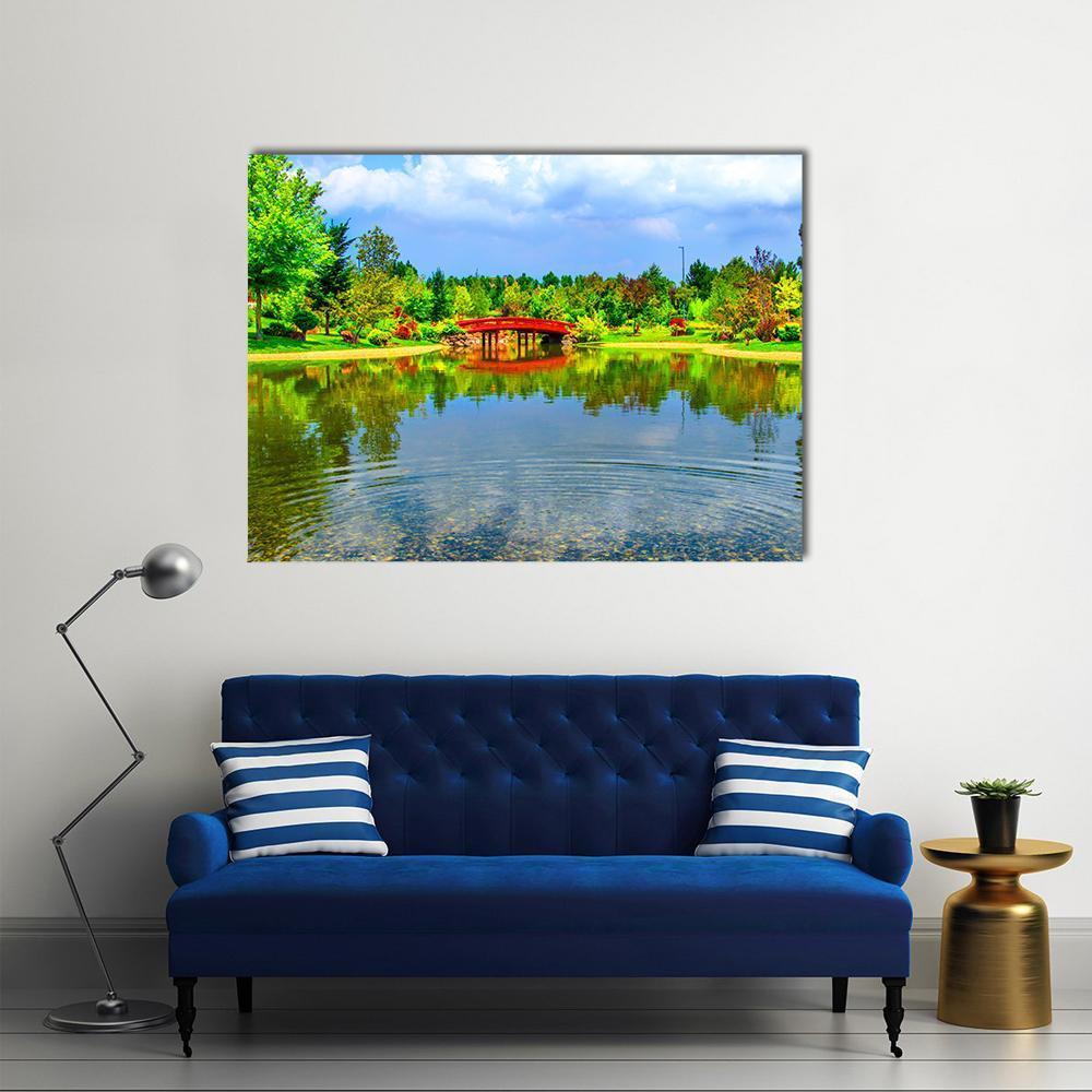 Japanese Garden with Red Arched Bridge Canvas Wall Art in red, green and blue, single panel hung on a wall