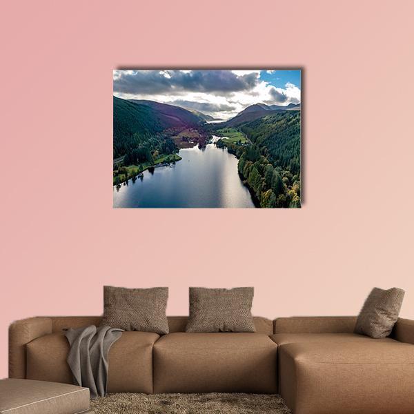 Sunlit Clouds Over Lake and Mountains Canvas Wall Art in white, green and blue, single panel hung on a wall