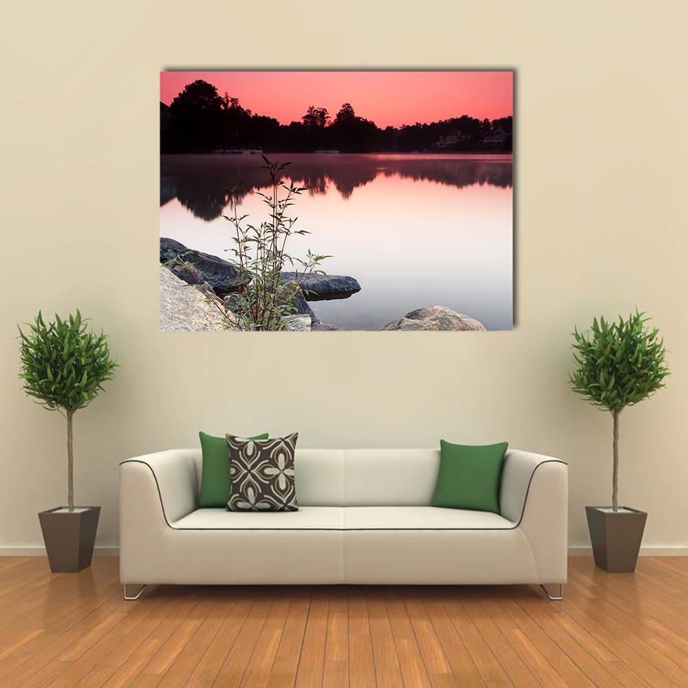Sunrise Over Lake and Houses Canvas Wall Art in black, gray and pink, single panel hung on a wall