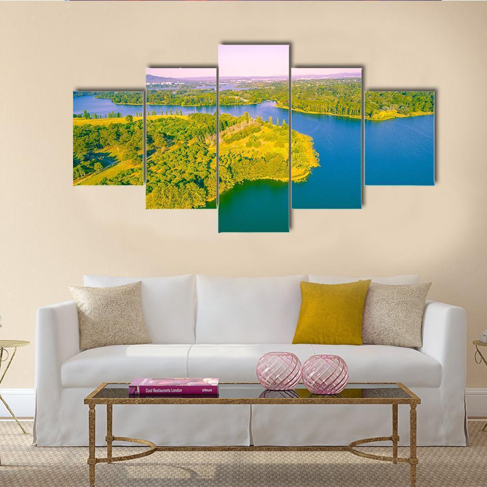 View of Lake Burley Griffin Canvas Wall Art in green, blue and purple, 5 panel Star layout hung on a wall