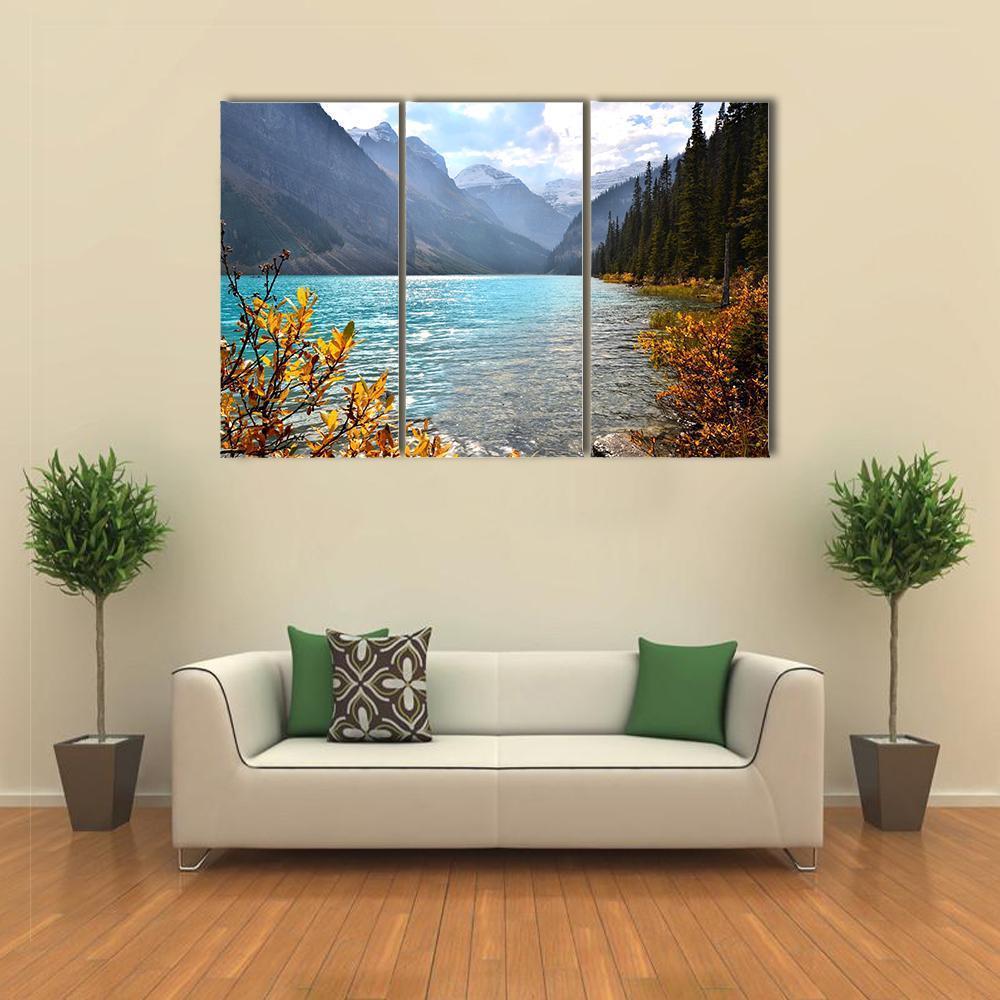 Autumn View of Lake Louise Canvas Wall Art in gray, brown and blue, 3 panel horizontal set hung on a wall
