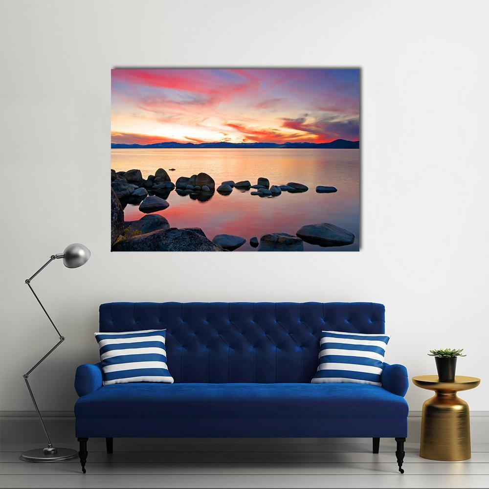 Lake Tahoe Sunrise with Reflections Canvas Wall Art in orange, blue and pink, single panel hung on a wall
