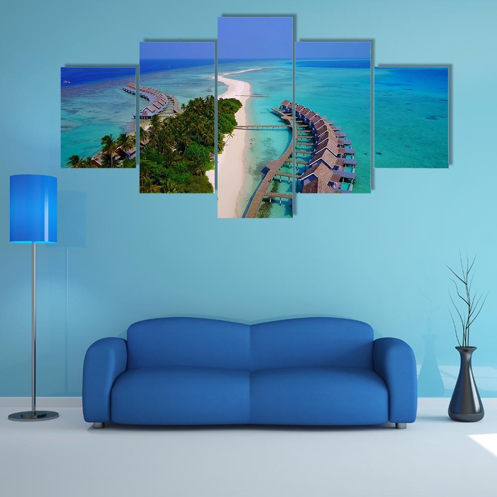 Maldives Overwater Bungalows Aerial View Canvas Wall Art in white, green and blue, 5 panel Star layout hung on a wall