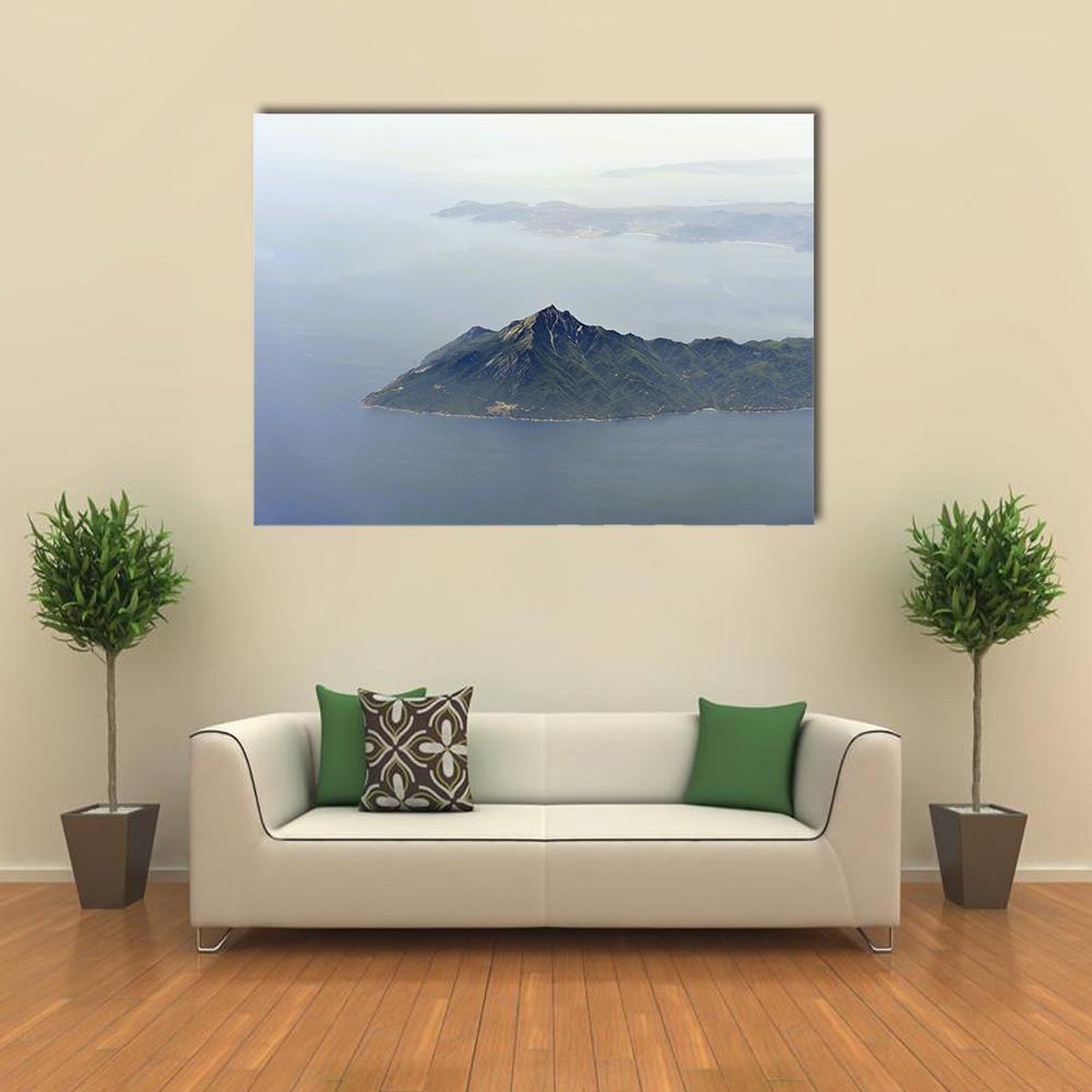 Island and Mountain Coastline Canvas Wall Art in white, gray and blue, single panel hung on a wall