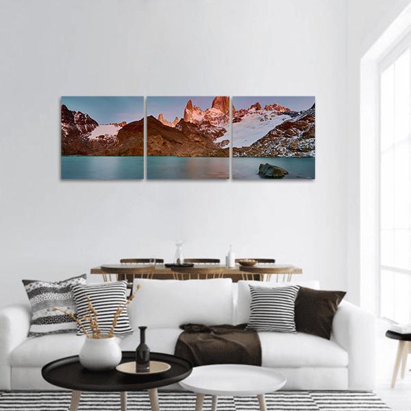 Mount Fitzroy at Sunrise Panoramic Canvas Wall Art in brown, orange and blue, hung on a wall