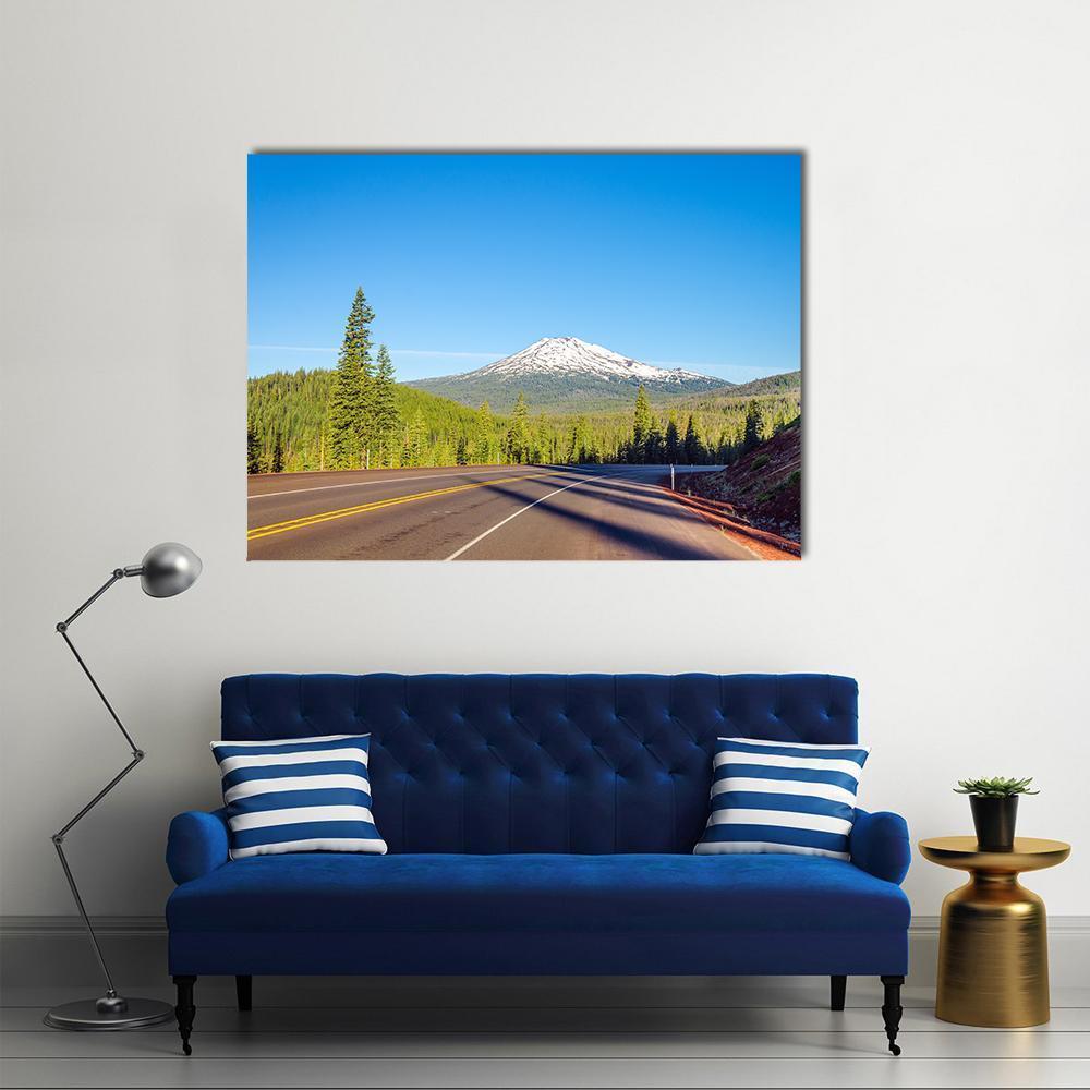Mt Bachelor Road Through Forest Canvas Wall Art in gray, green and blue, single panel hung on a wall