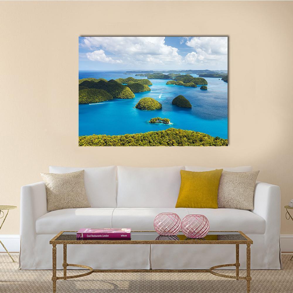 Tropical Island Aerial View Canvas Wall Art in green and blue, single panel hung on a wall