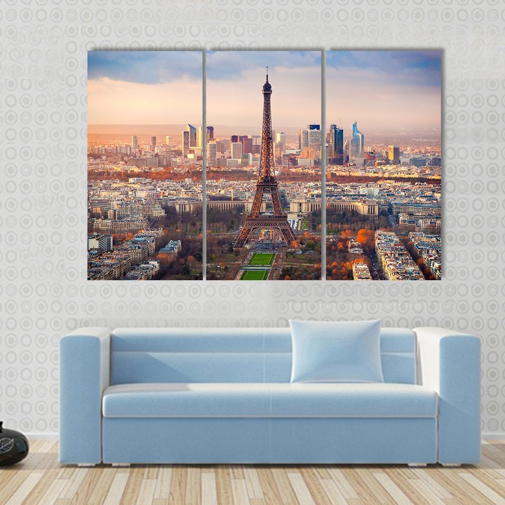 Eiffel Tower at Sunset Over Paris Canvas Wall Art in orange, yellow and blue, single panel hung on a wall