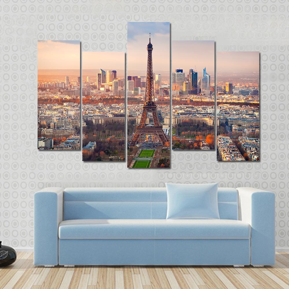 Eiffel Tower at Sunset Over Paris Canvas Wall Art in orange, yellow and blue, single panel hung on a wall