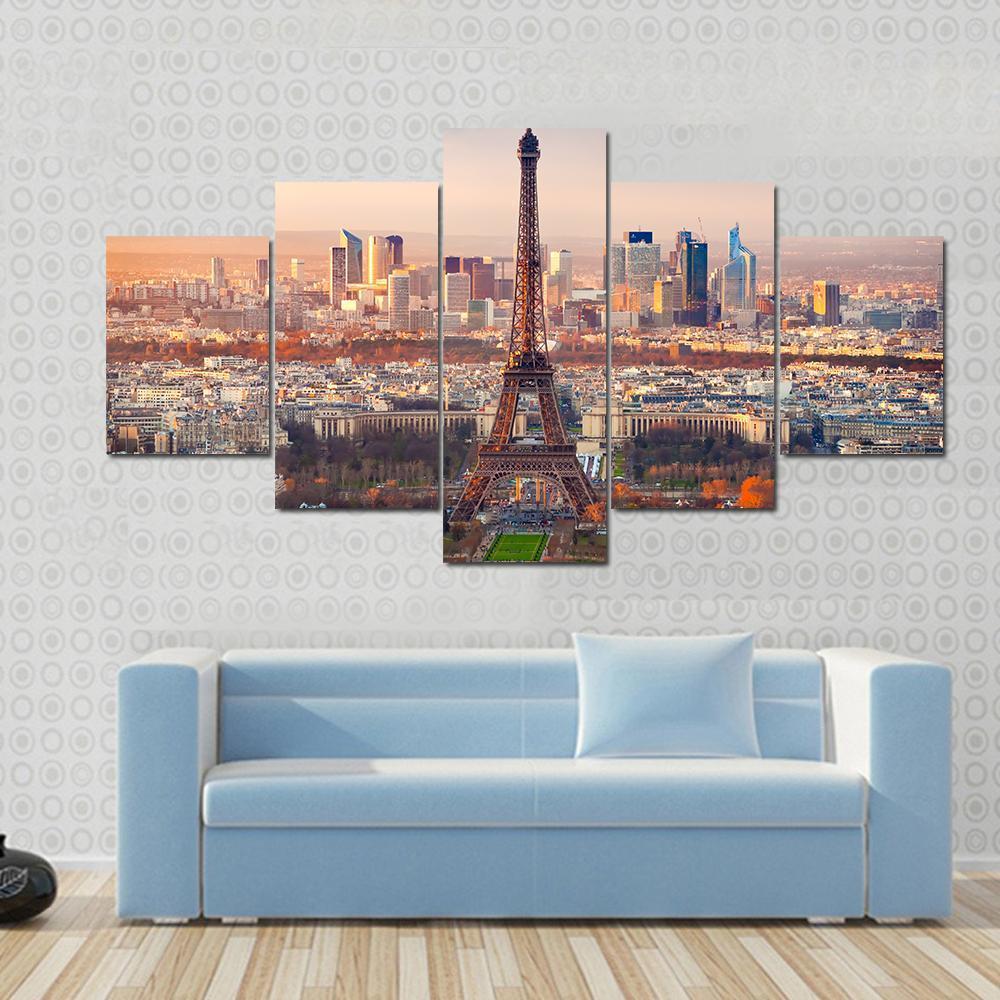 Eiffel Tower at Sunset Over Paris Canvas Wall Art in orange, yellow and blue, single panel hung on a wall