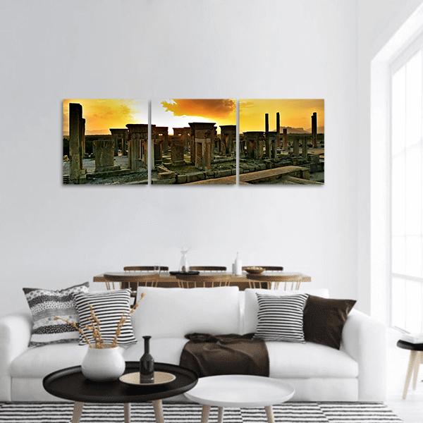 Persepolis Ruins at Sunset Panoramic Canvas Wall Art in brown, orange and yellow, hung on a wall