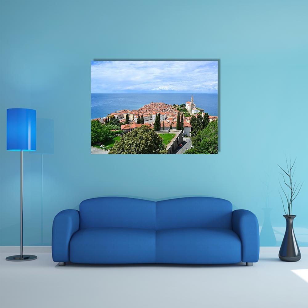 View of Piran, Slovenia Canvas Wall Art in orange, green and blue, single panel hung on a wall
