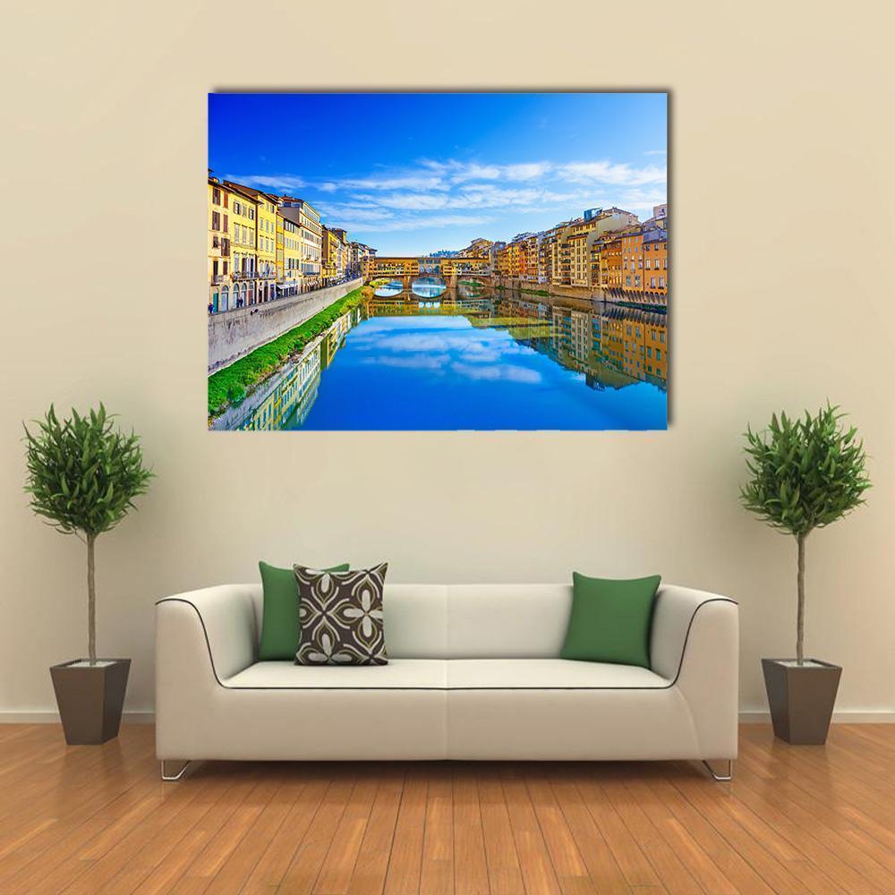 Ponte Vecchio and the Arno, Florence Canvas Wall Art in orange, yellow and blue, single panel hung on a wall
