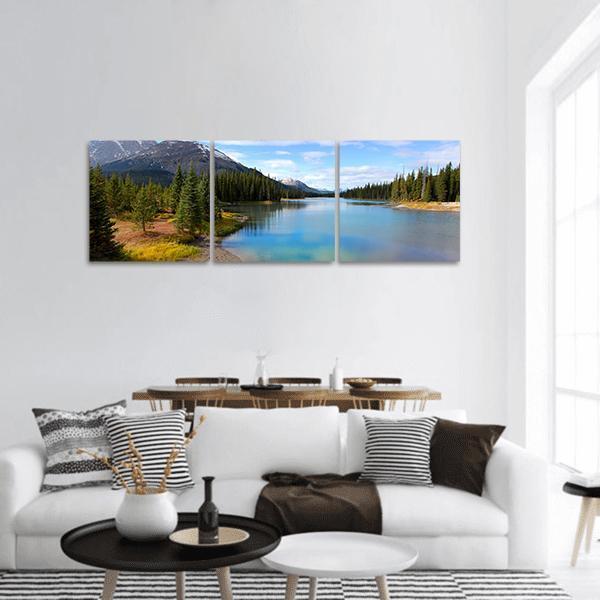 Porcupine Creek Lake View Panoramic Canvas Wall Art in brown, green and blue, hung on a wall