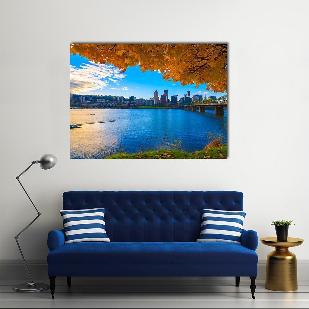 Riverfront City Skyline with Bridge Canvas Wall Art in orange, yellow and blue, single panel hung on a wall