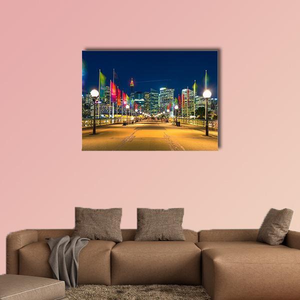 Pyrmont Bay Night Skyline with Pier Flags Canvas Wall Art in black, yellow and blue, single panel hung on a wall