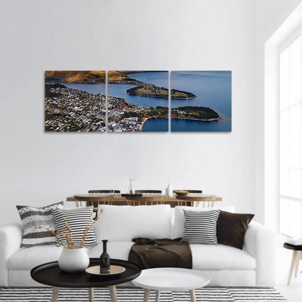 Aerial View of Queenstown and Lake Wakatipu Panoramic Canvas Wall Art in gray, brown and blue, hung on a wall