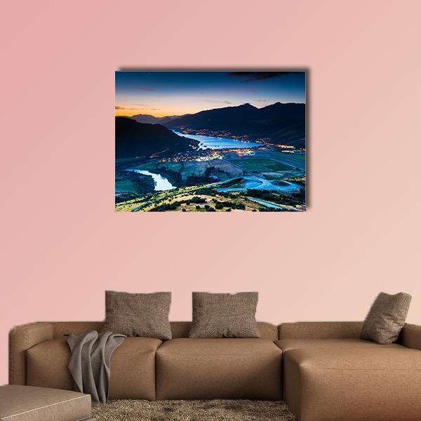 Aerial View of Queenstown at Dusk Canvas Wall Art in black, orange and blue, single panel hung on a wall
