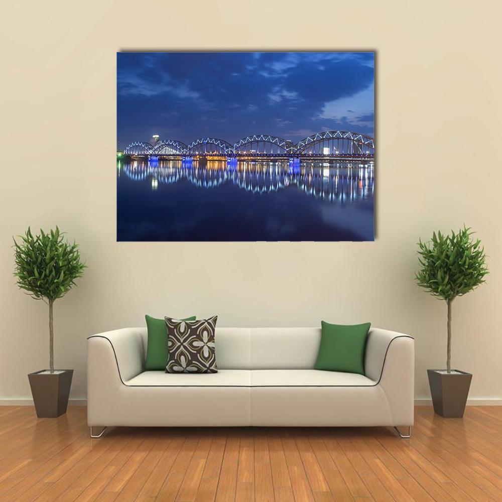 Illuminated Rail Bridge Reflections Canvas Wall Art in black and blue, single panel hung on a wall
