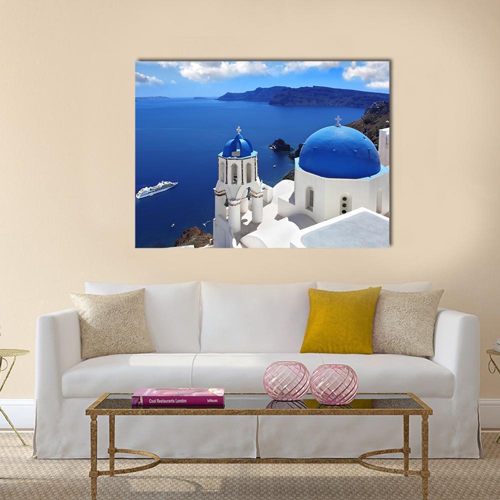 Santorini Island with Blue Domed Church Canvas Wall Art in white and blue, single panel hung on a wall