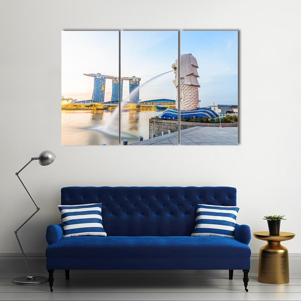 Merlion and Marina Bay Sands Singapore Skyline Canvas Wall Art in white, yellow and blue, 3 panel horizontal set hung on a wall