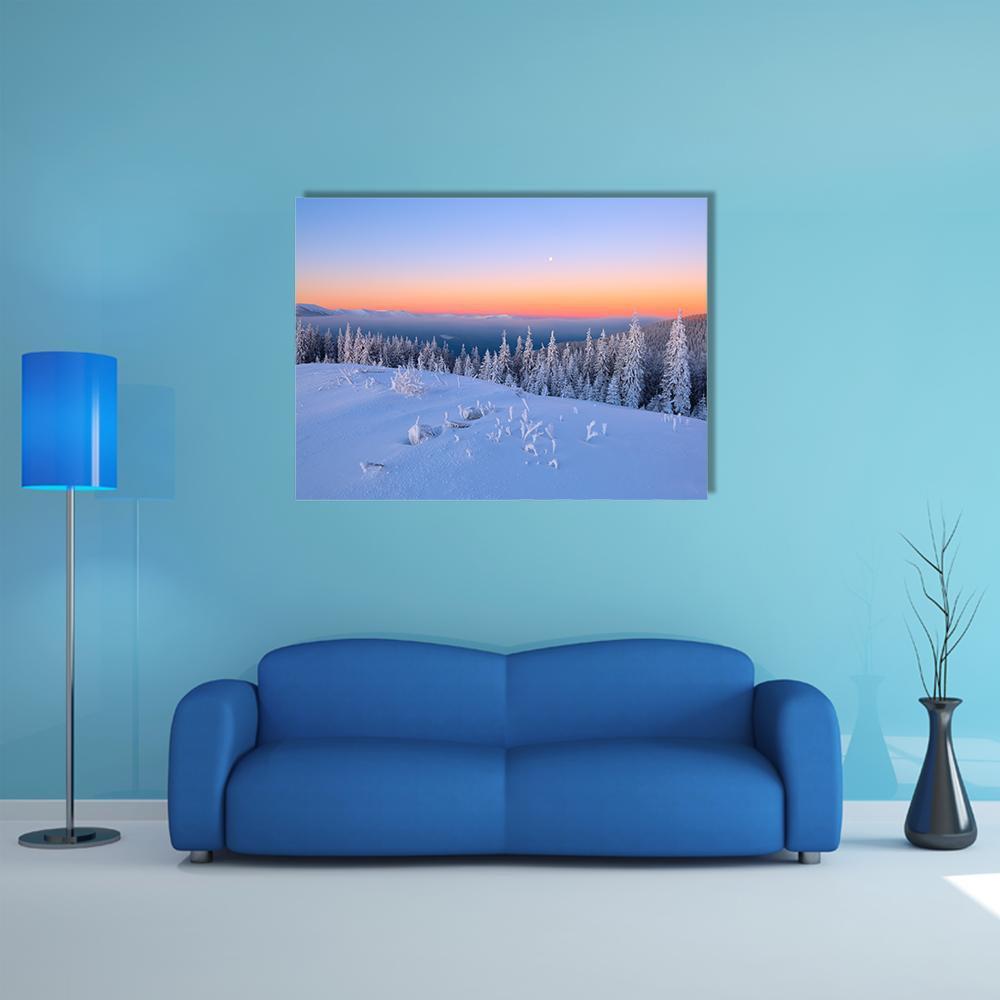 Snow-covered Trees at Sunset Canvas Wall Art in white, orange and blue, single panel hung on a wall