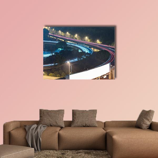 Night Overpass with Light Trails Canvas Wall Art in black, red and blue, single panel hung on a wall