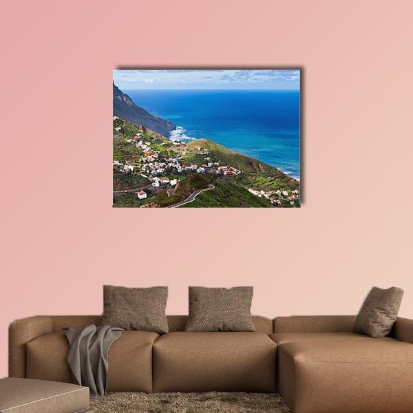 Coastal Village on Lush Hillside Canvas Wall Art in green and blue, single panel hung on a wall