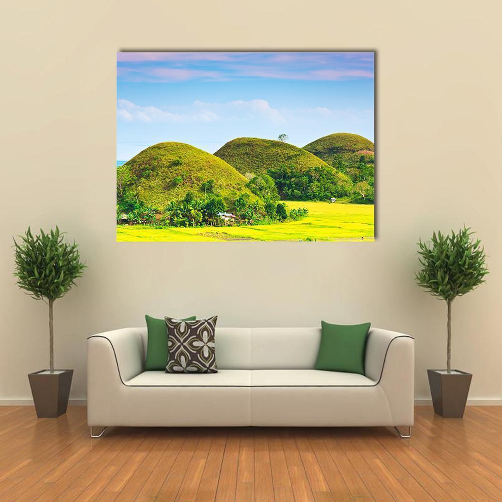 View of the Chocolate Hills Canvas Wall Art in yellow, green and blue, single panel hung on a wall