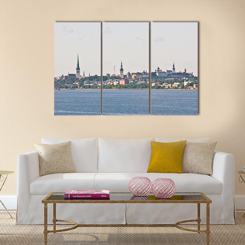 Tallinn Cityscape from the Sea Canvas Wall Art in white, gray and blue, 3 panel horizontal set hung on a wall