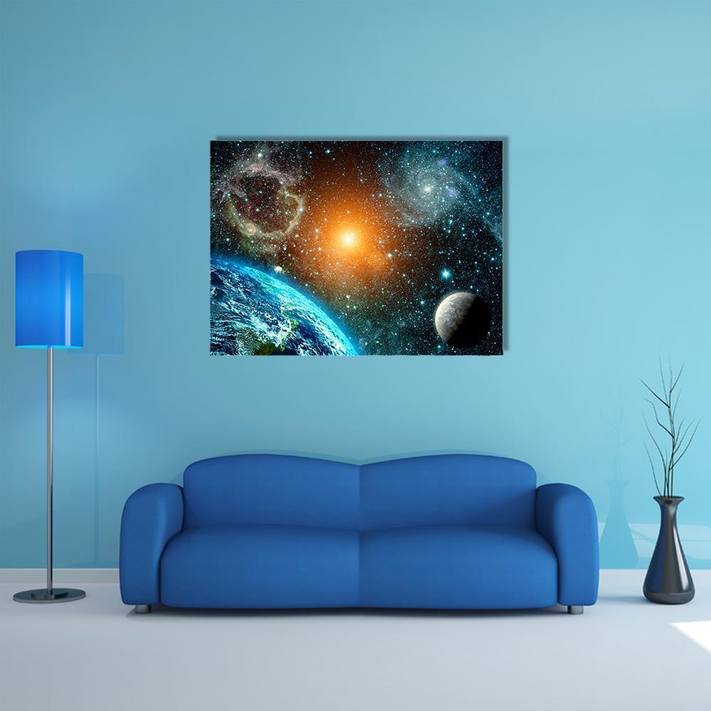 Earth with Crescent Moon and Nebula Canvas Wall Art in black, orange and blue, single panel hung on a wall