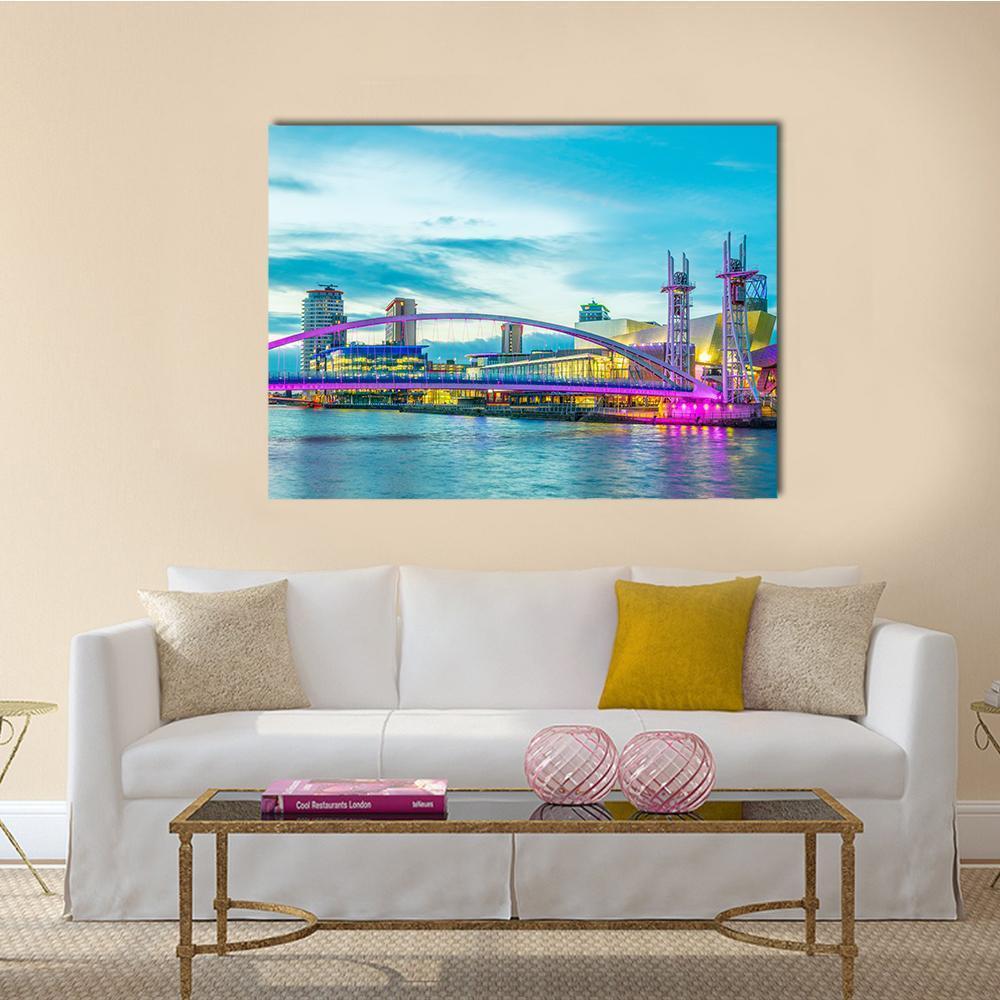 Lowry Theater Night Skyline with Bridge Canvas Wall Art in blue, purple and pink, single panel hung on a wall