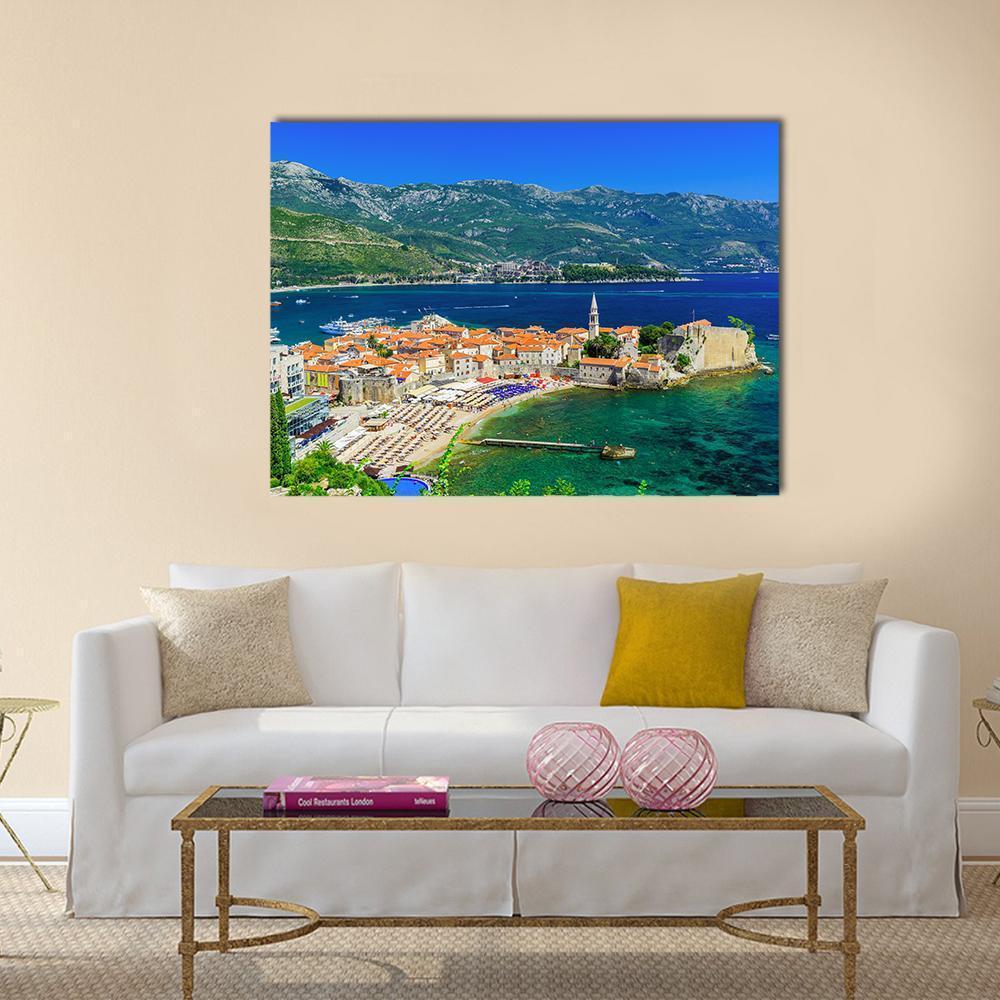 Old Town Budva Seaside View Canvas Wall Art in orange, green and blue, single panel hung on a wall