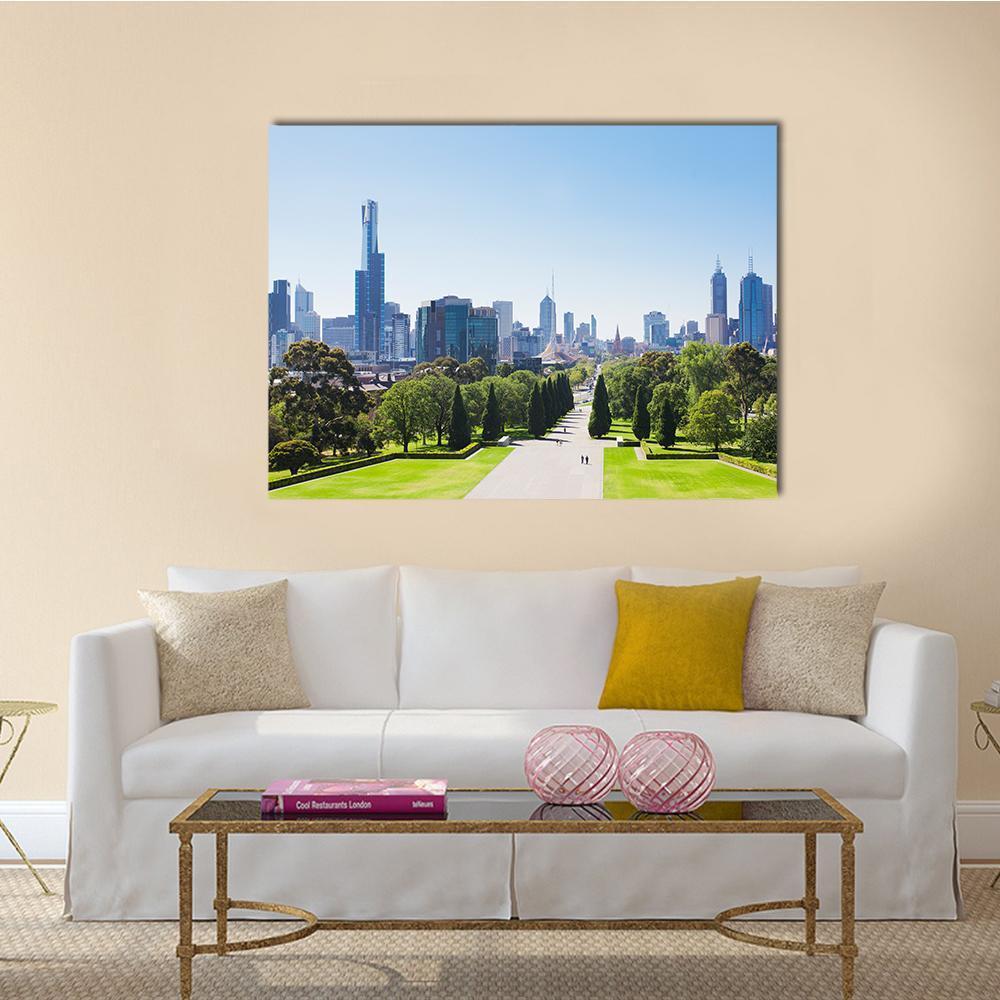 City Skyline with Park Path Canvas Wall Art in gray, green and blue, single panel hung on a wall