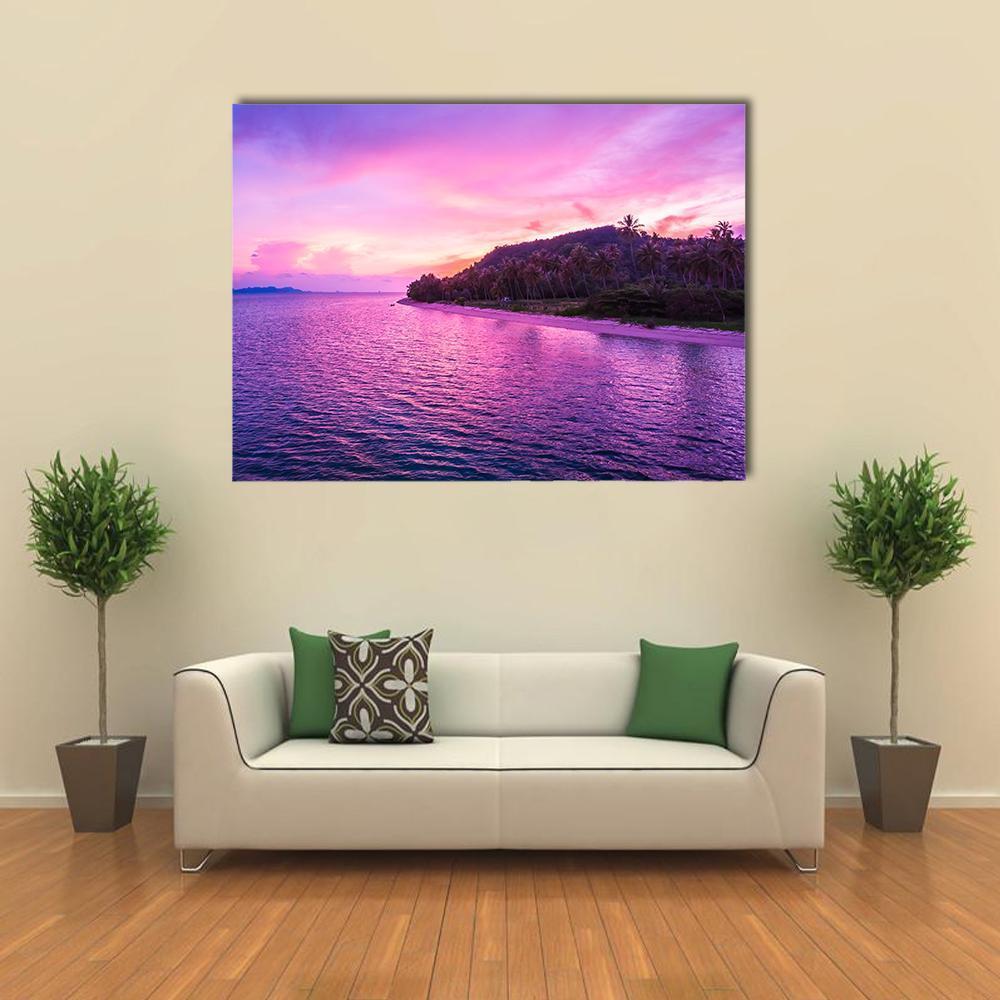 Tropical Beach Sunset with Palm Trees Canvas Wall Art in orange, purple and pink, single panel hung on a wall
