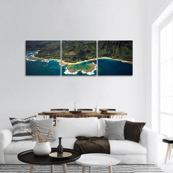 Tunnels Beach Aerial Coastline View Panoramic Canvas Wall Art in green and blue, hung on a wall