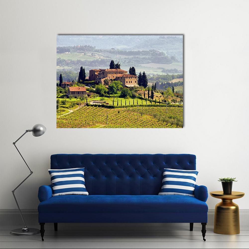 Tuscan Vineyard View Canvas Wall Art in yellow, green and blue, single panel hung on a wall