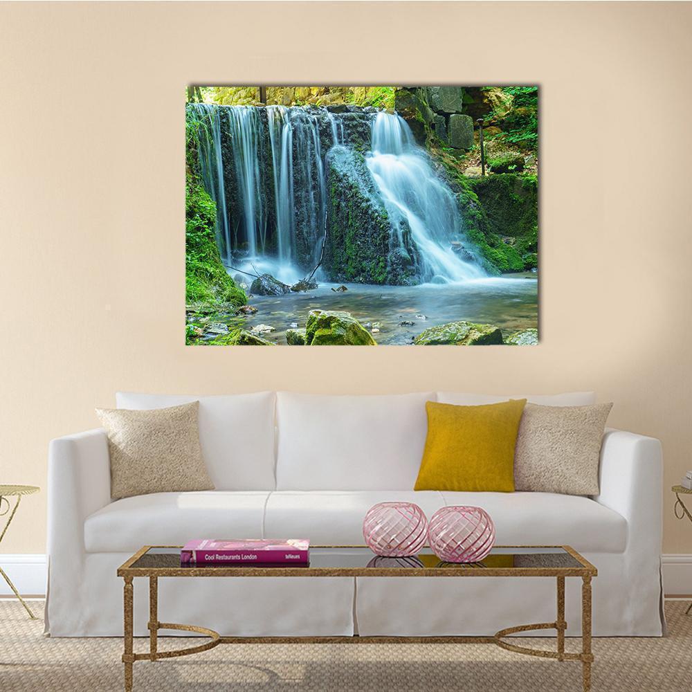 Silky Waterfall Over Mossy Rocks Canvas Wall Art in white, gray and green, single panel hung on a wall