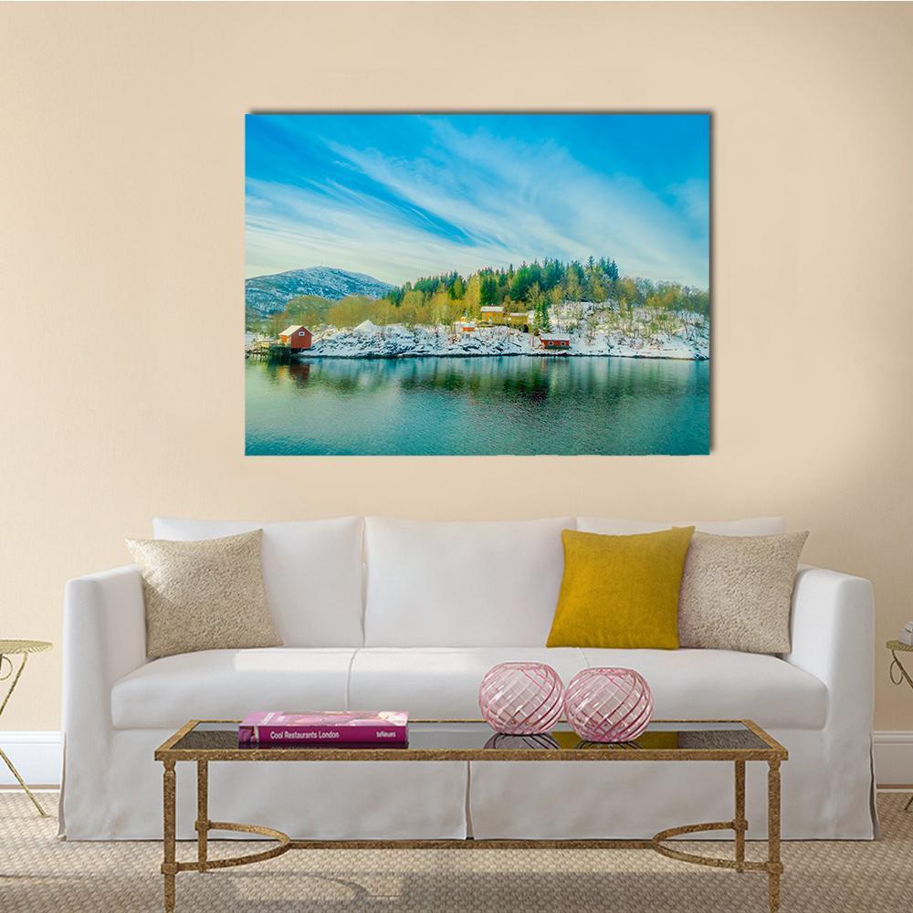 Red Cabins by Snowy Lake Canvas Wall Art in white, green and blue, single panel hung on a wall
