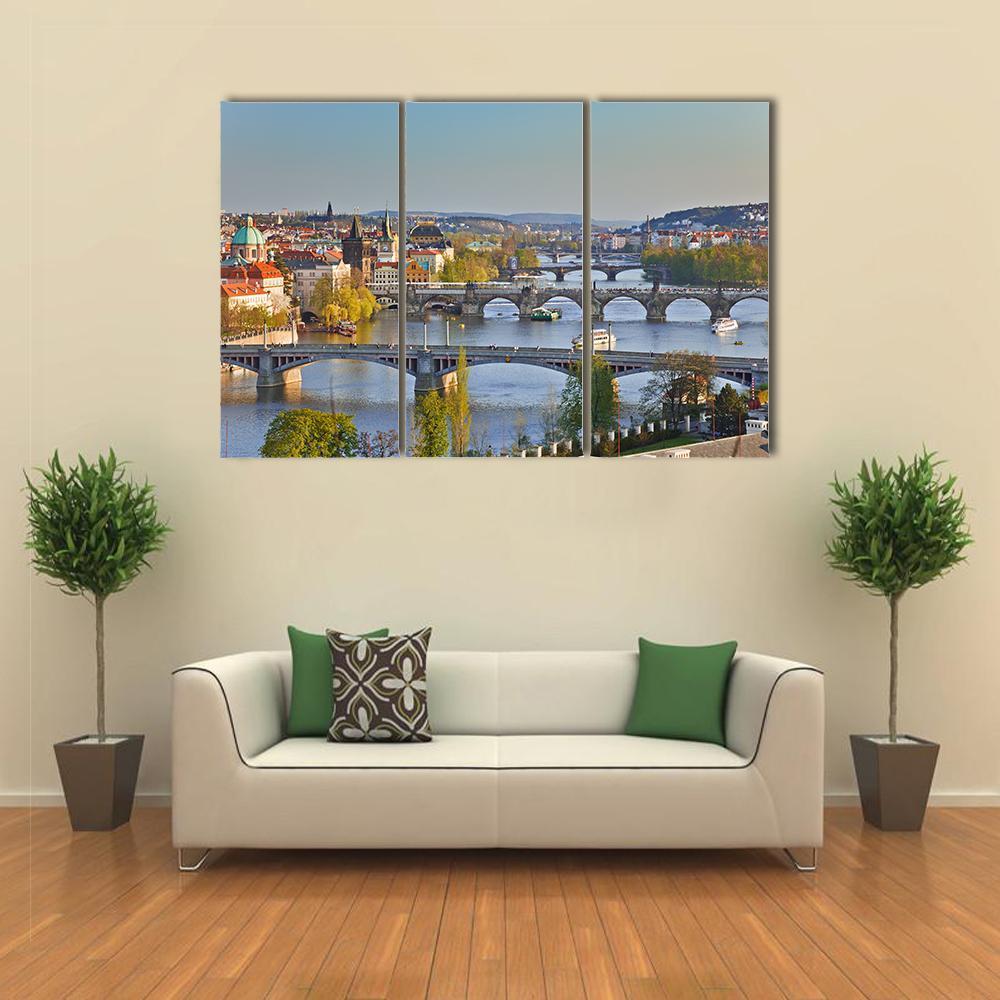 Stone Bridges Over River at Sunset Canvas Wall Art in gray, yellow and blue, 3 panel horizontal set hung on a wall