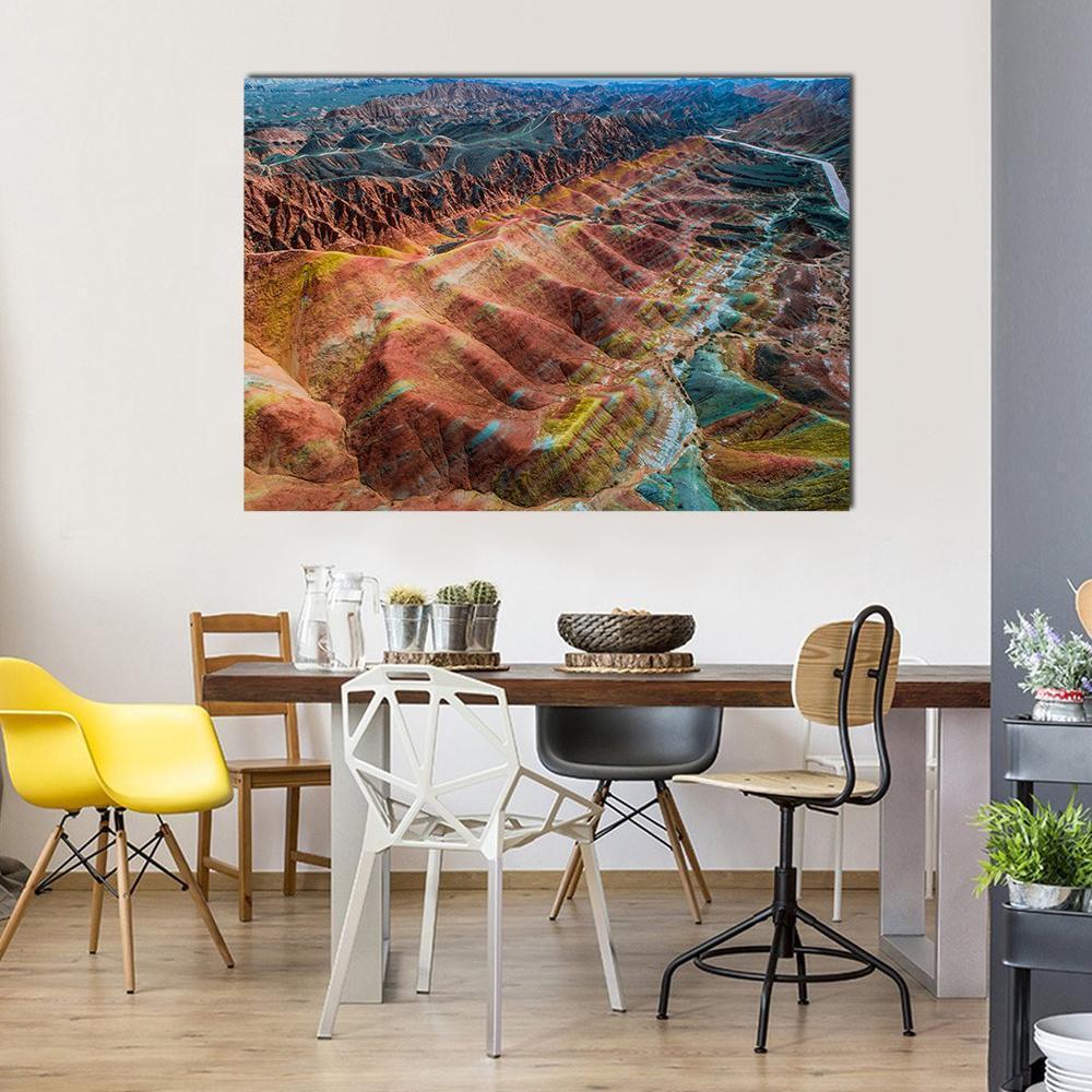 Colorful Rainbow Mountains View Canvas Wall Art in red, orange and multicolor, single panel hung on a wall