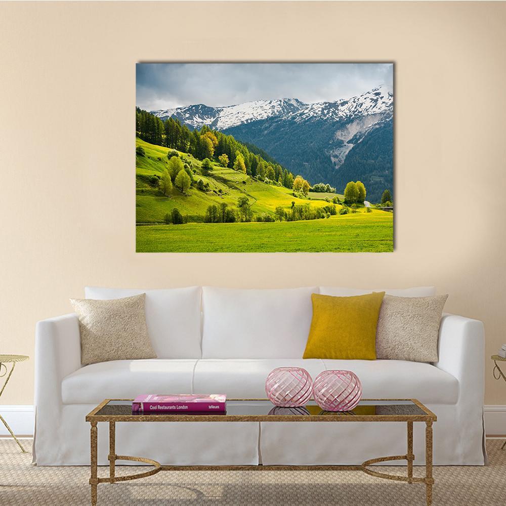 Alpine Summer Meadow with Snow-capped Peaks Canvas Wall Art in white, green and blue, single panel hung on a wall